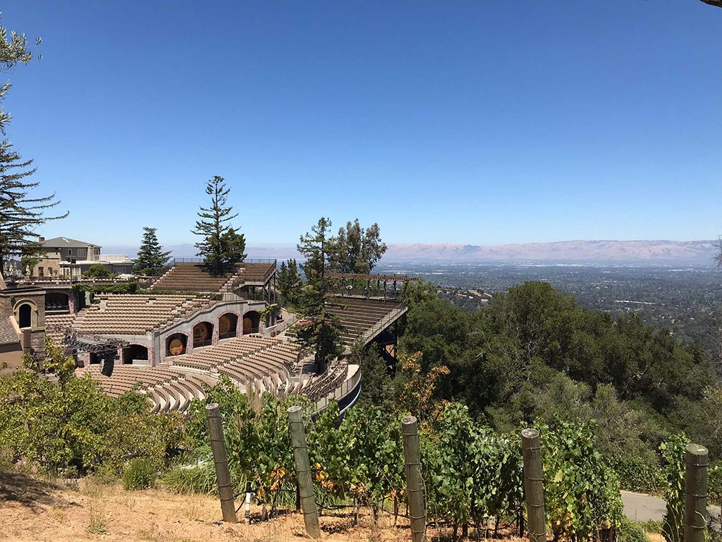 A view of the stadium seating at mountain winery with a mountain range in the background.